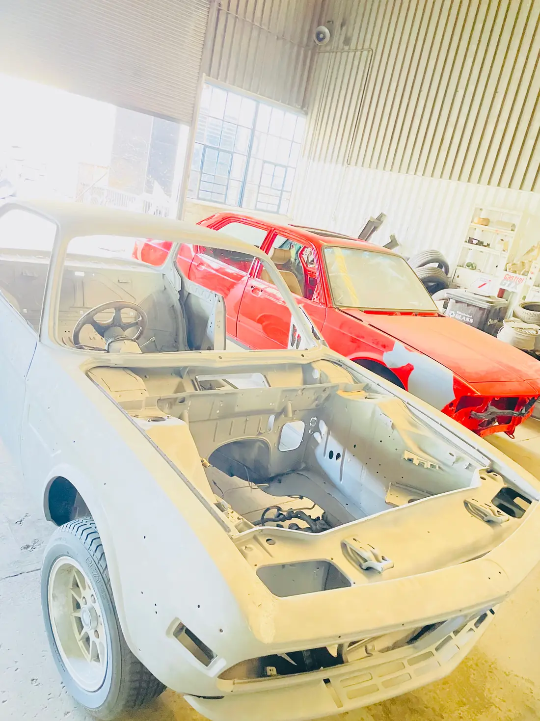 Classic car body shell sandblasted to bare metal for restoration
