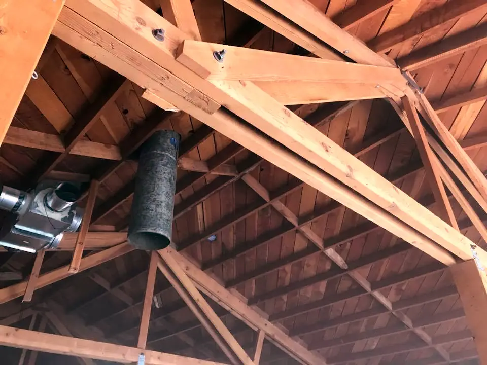 Timber roof trusses restored by blasting, wood grain revealed