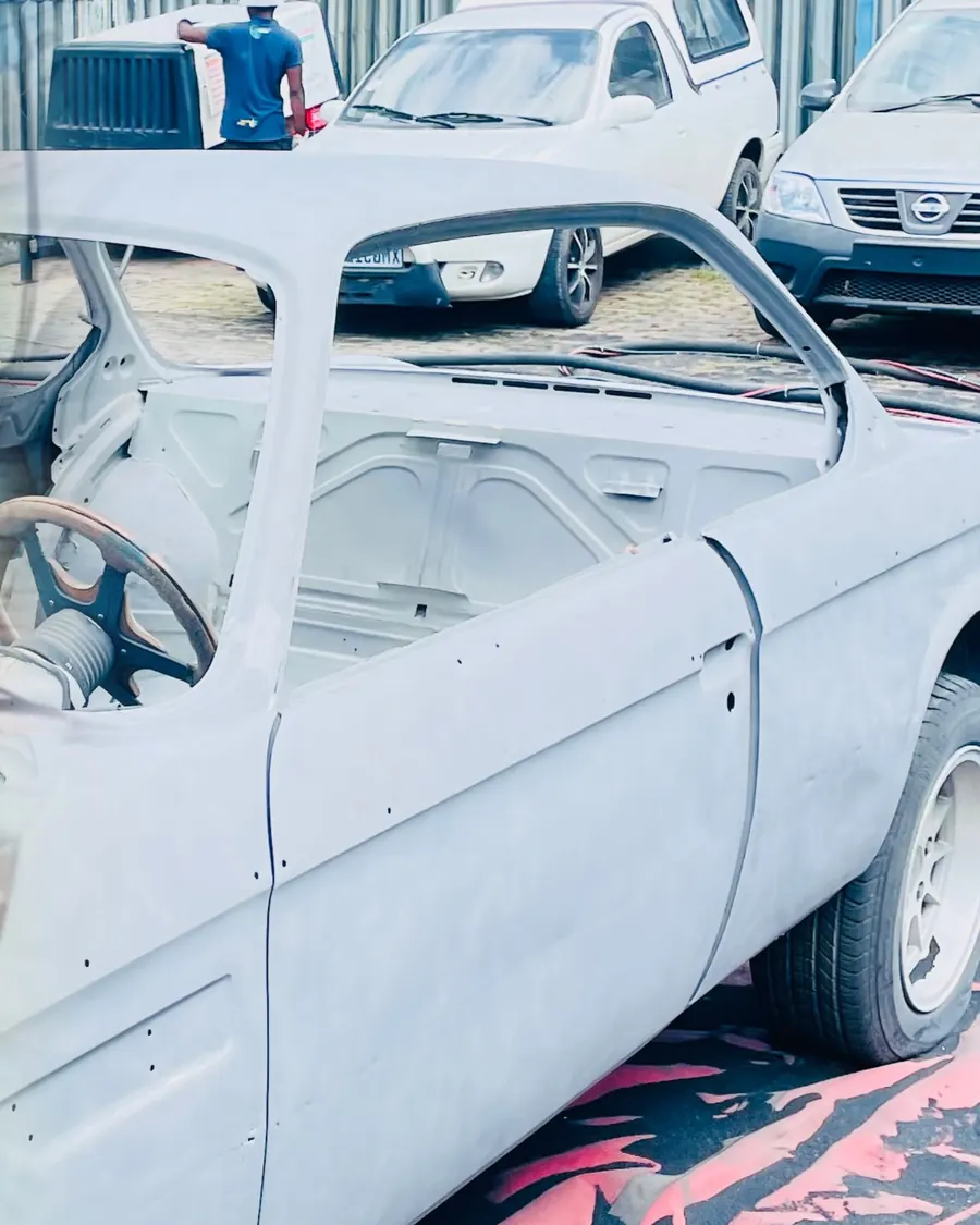 Classic car body stripped to bare metal after sandblasting